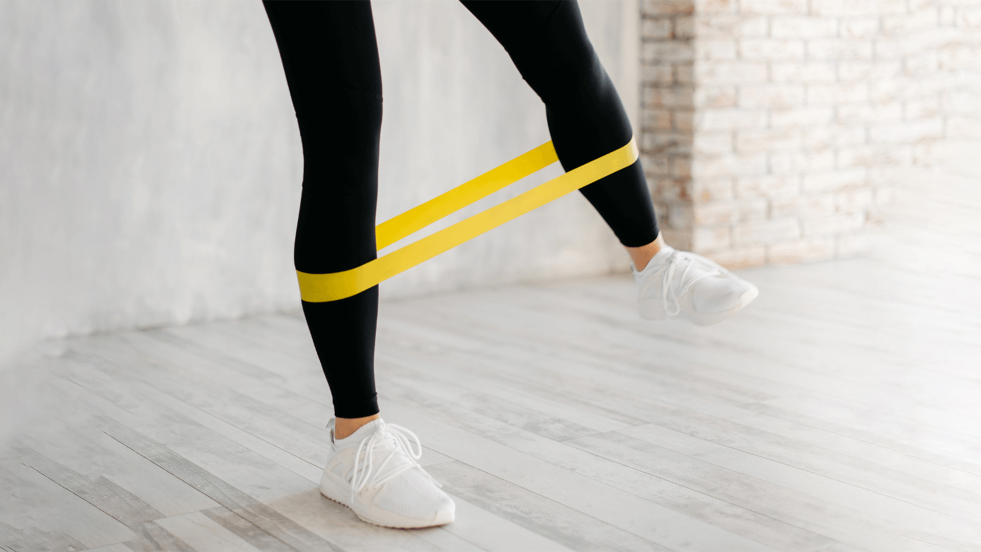 Woman/Man using a resistance band for muscle toning